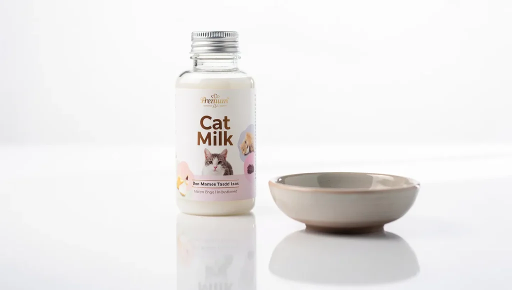 Bottle of cat-safe milk next to a bowl